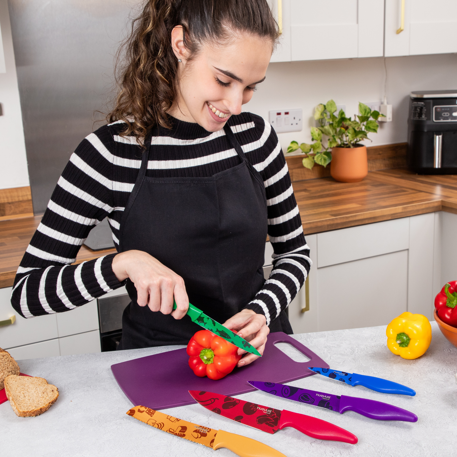 Nuovva 5 pcs kitchen knife set with colored patterned design for ease of use including chefs knife and paring knife.