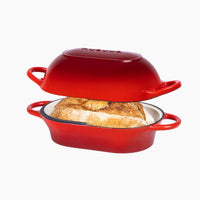 Red enameled cast iron loaf pan with lid for home bread baking.