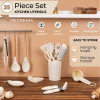 Nuovva 35pcs cream kitchen utensil which are heat resistant, non-scratch and durable with hanging loops and a storage holder for easy organization.