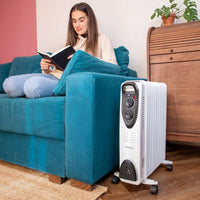 White oil-filled radiator heater with wheels for portable home heating