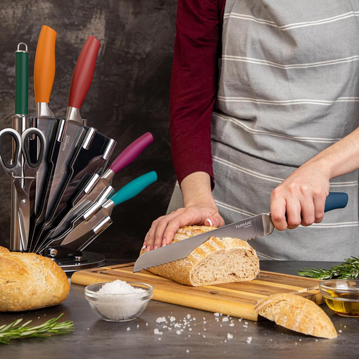 Stainless steel kitchen knife set with rotating block including serrated bread knife with coloured handles.
