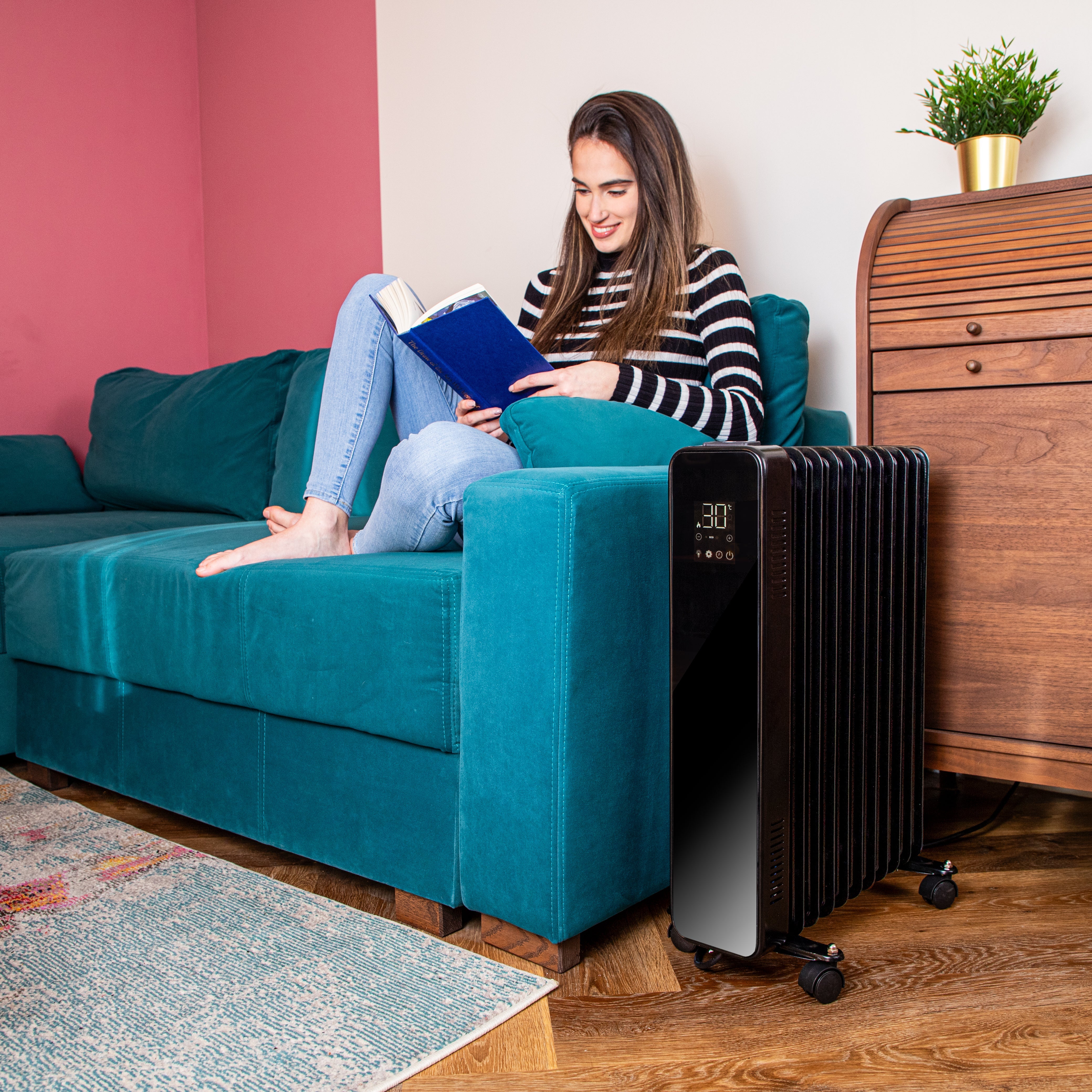 Black touchscreen radiator heater with wheels for portable heating at home.