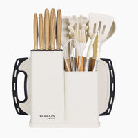 Nuovva cream kitchen utensil and knife set with chopping board and storage block for home organization. 