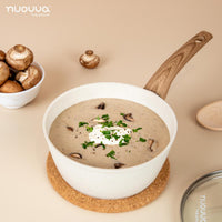 Cream ceramic saucepan with lid for stewing and cooking. 