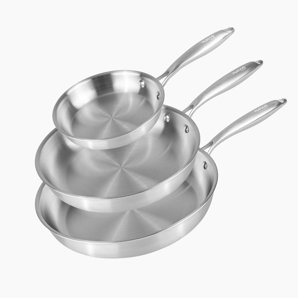 Set of three stainless steel frying pans stacked