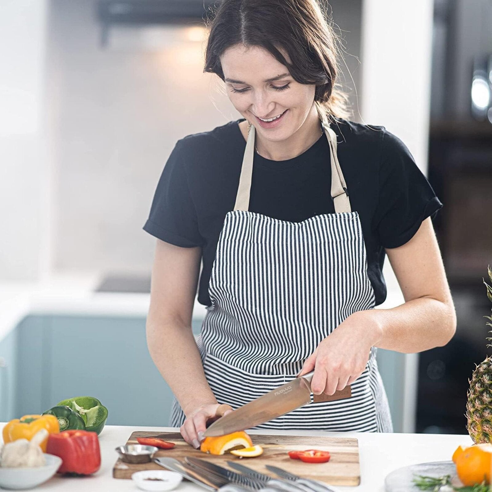 Woman using Nuovva stainless steel kitchen knife 