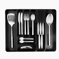 Adjustable cutlery drawer organizer with extendable sides and knife slots.
