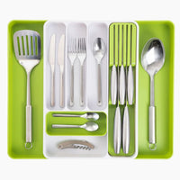 White & green adjustable cutlery drawer organizer with removable parts and slotted knife section for organized kitchens. 