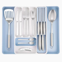 Adjustable cutlery drawer organizer with extendable design and knife slots for easy kitchen organization. 
