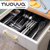 Open kitchen drawer displaying the black cutlery organizer for drawers