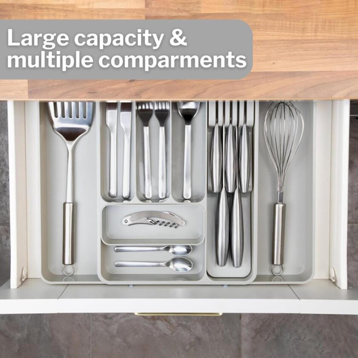 Light grey adjustable cutlery drawer with multiple compartments. 