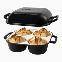 Black oven safe cast iron bread pan with 4 compartments for homemade bread.