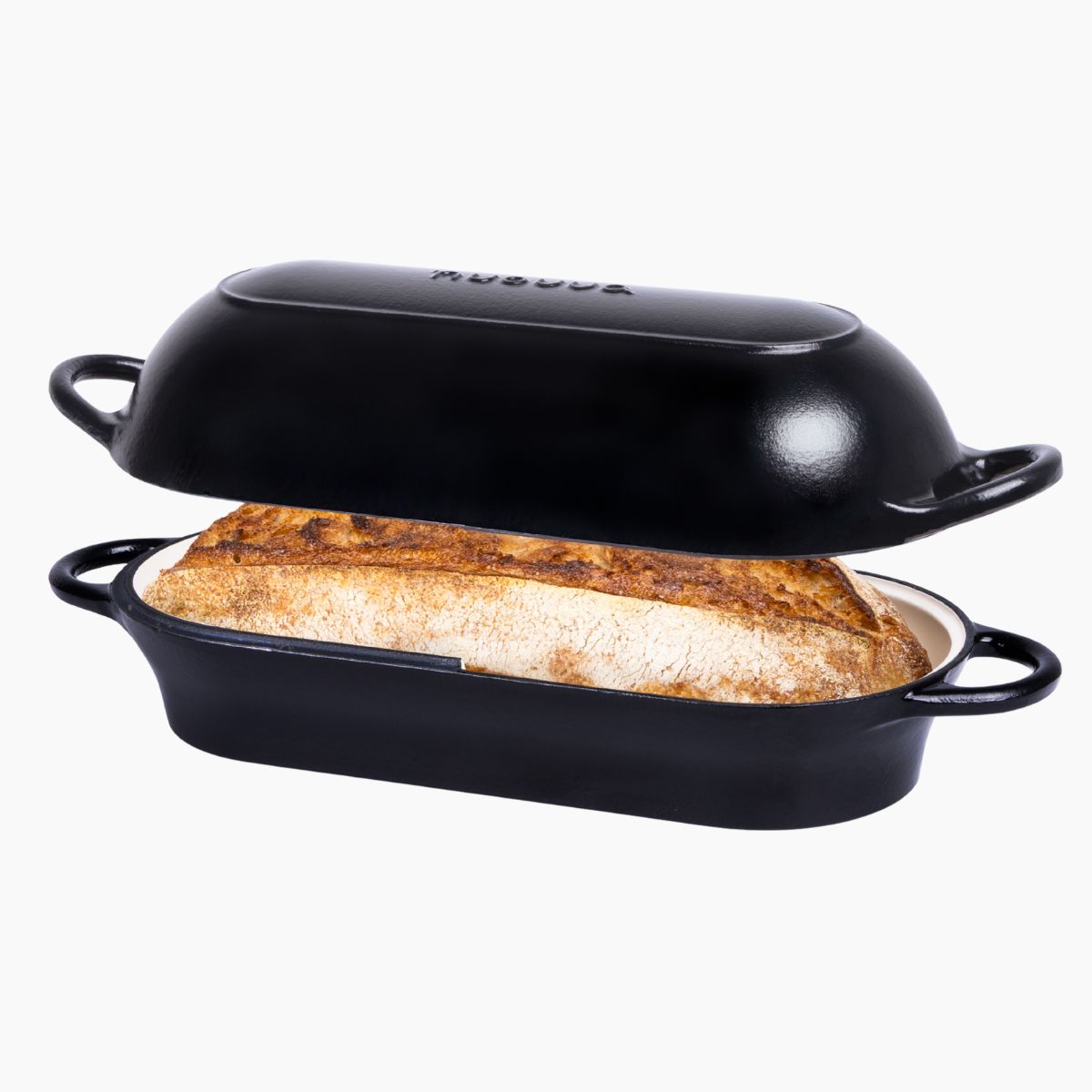 Black cast iron bread loaf pan with a loaf of home baked sourdough, 