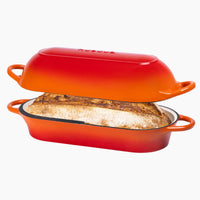 Nuovva  orange cast iron bread loaf pan Dutch oven with sourdough inside. 