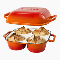 Nuovva orange QuadPro cast iron baking loaf pan with 4 compartments and lid of bread baking.