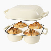 Cream cast iron bread loaf pan with four compartments containing bread loaves for home baked bread