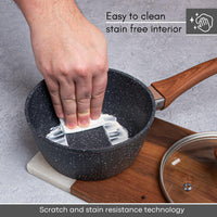 Easy to clean grey granite saucepan with wooden handle and glass lid. 