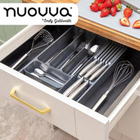 Adjustable Cutlery organizer in a kitchen drawer with utensils 
