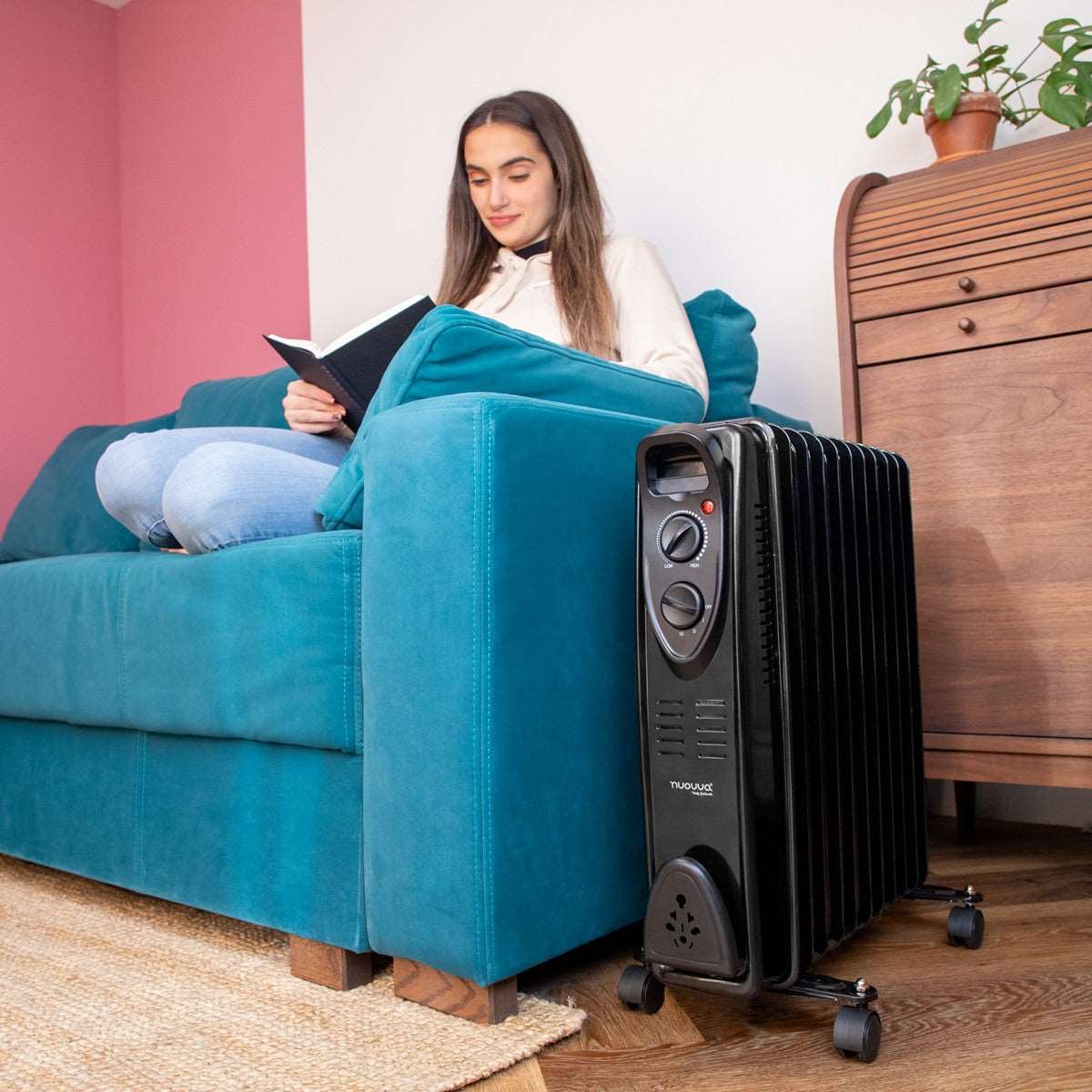 Black oil-filled radiator heater for portable home heating with adjustable thermostat and 3 heat settings. 