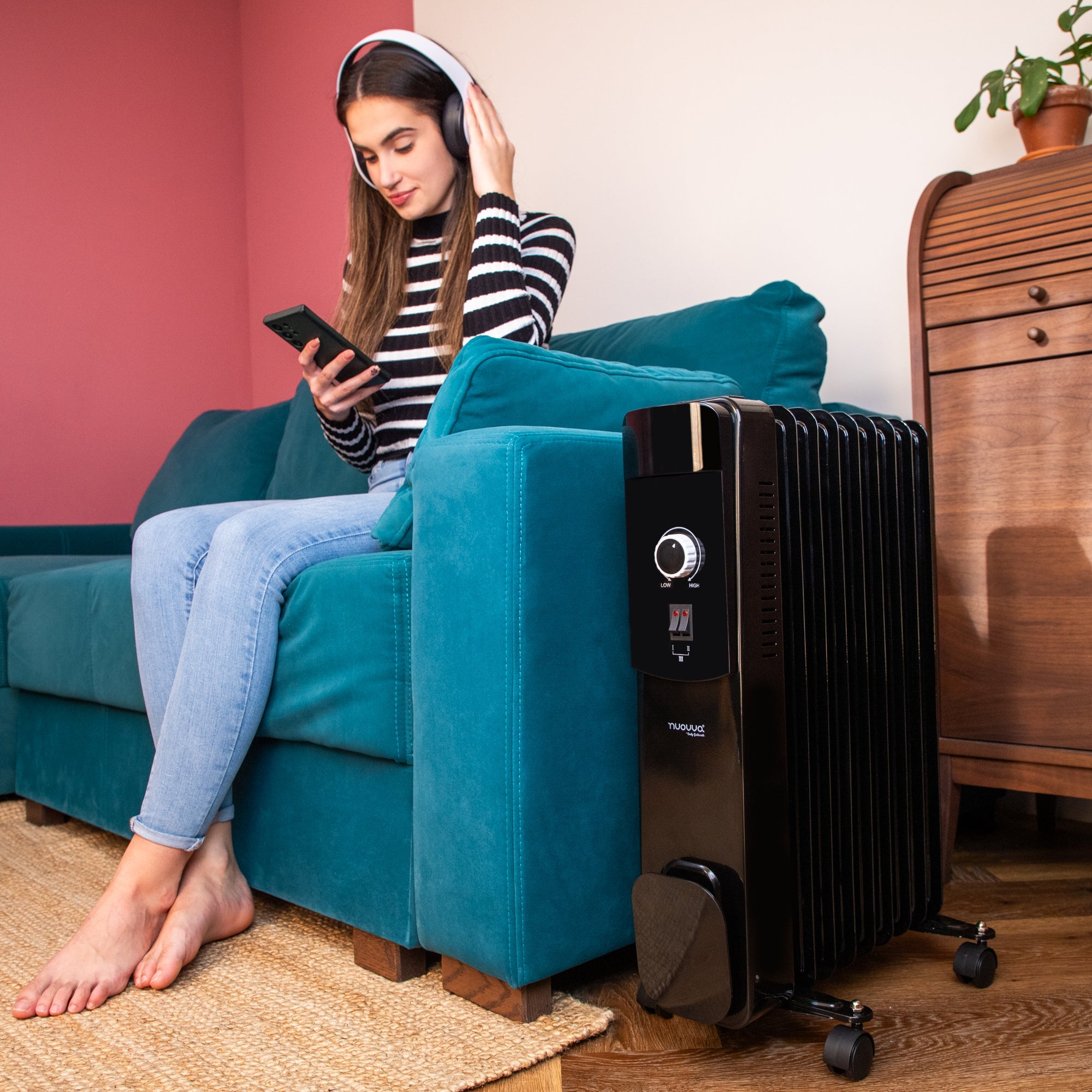 Black portable heater with adjustable thermostat for home heating. 
