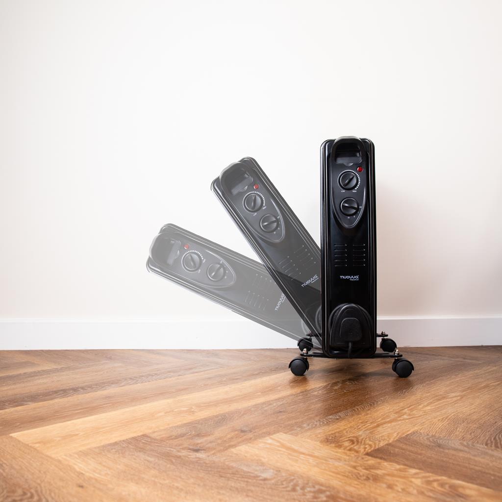 Black oscillating radiator heater with wheels for portable heating. 